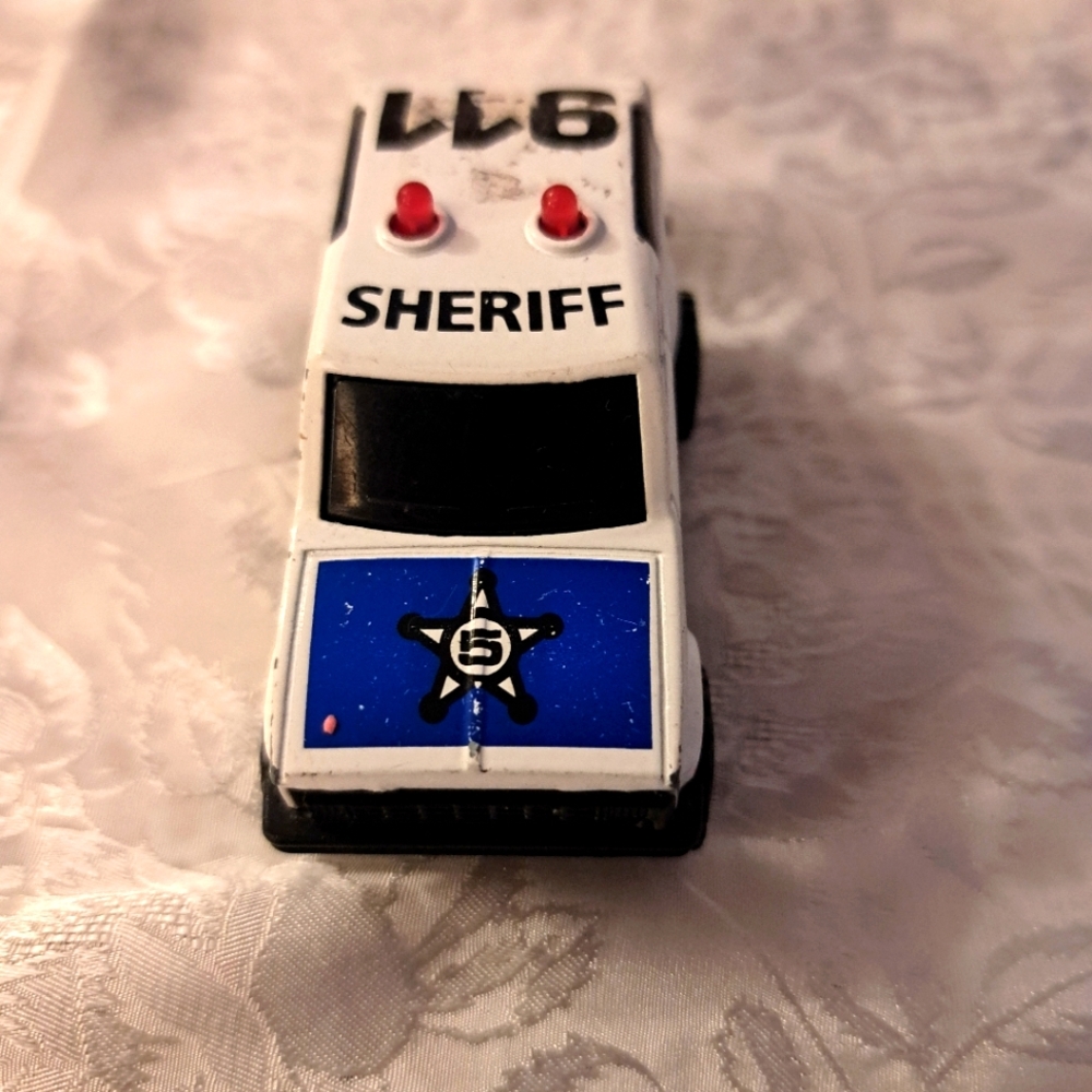 Retro White and Blue Police Vehicle.
